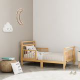 natural toddler bed with guardrails in nursery