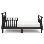 Side view of black toddler bed with guardrails