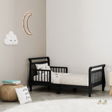 black toddler bed with guardrails in nursery