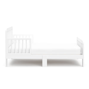 side view of a white toddler bed