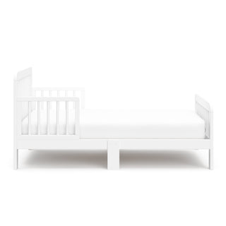 side view of a white toddler bed