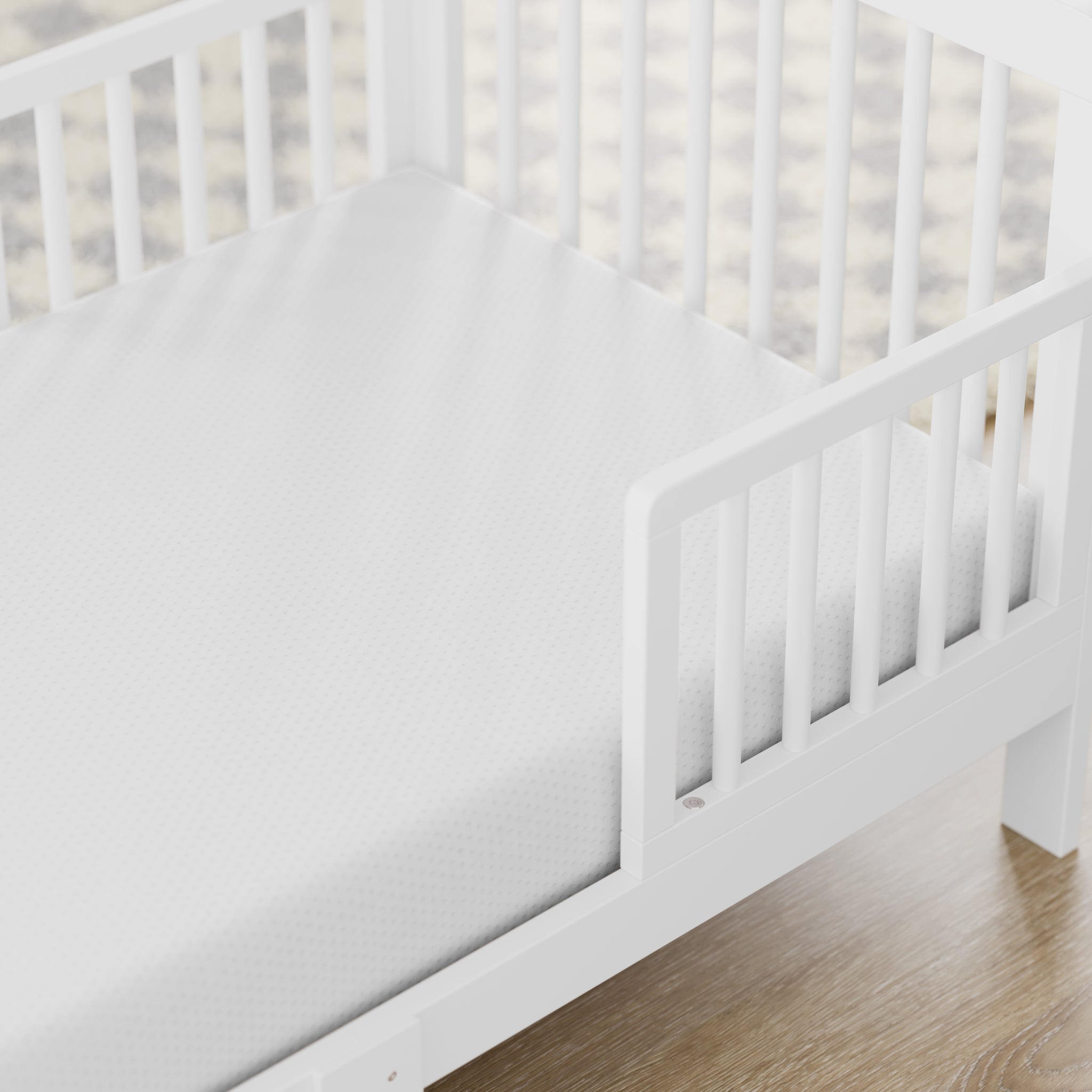 Close-up view of a mattress in a toddler bed in a room