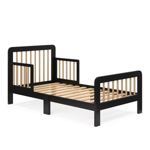Angled view of a black toddler bed with driftwood finish