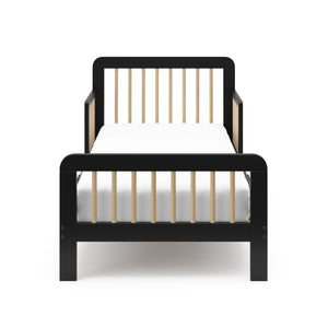 Front view of a black toddler bed with driftwood finish