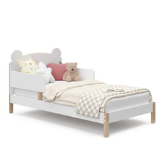 Angled view of white with driftwood toddler bed