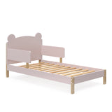 Angled view of a blush-colored toddler bed