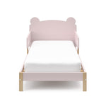 front view of a blush-colored toddler bed