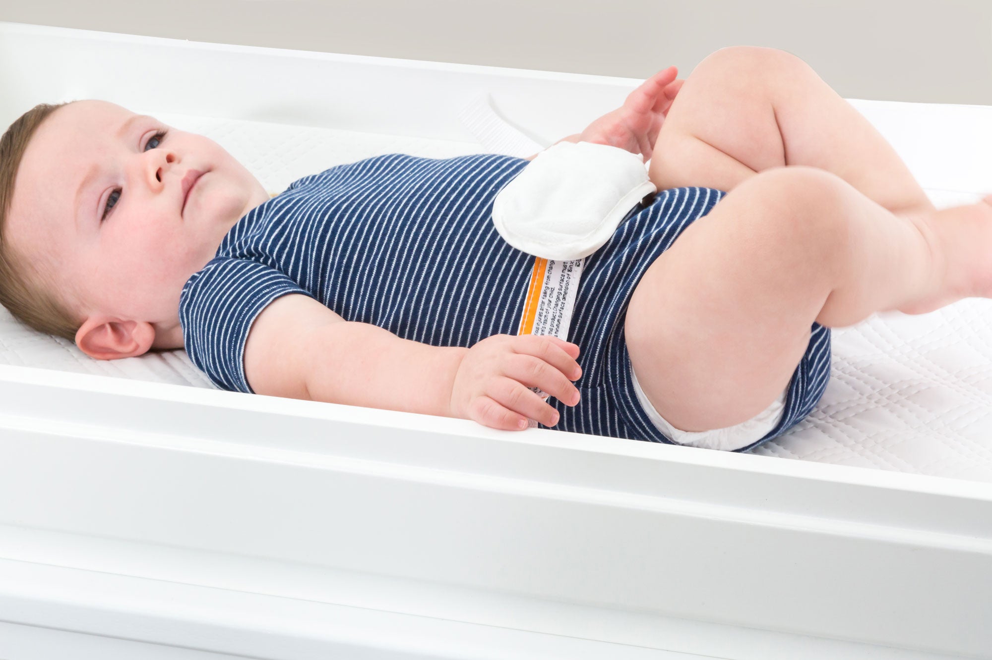 white changing pad with baby