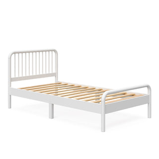 angled view of white twin bed without mattress