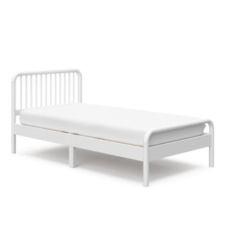 angled view of white twin bed 