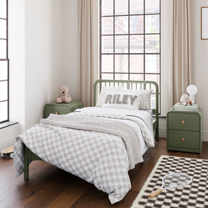 Olive green kids bed with matching olive green nightstands, in a kids bedroom setting with various decorative objects and bedroom accessories