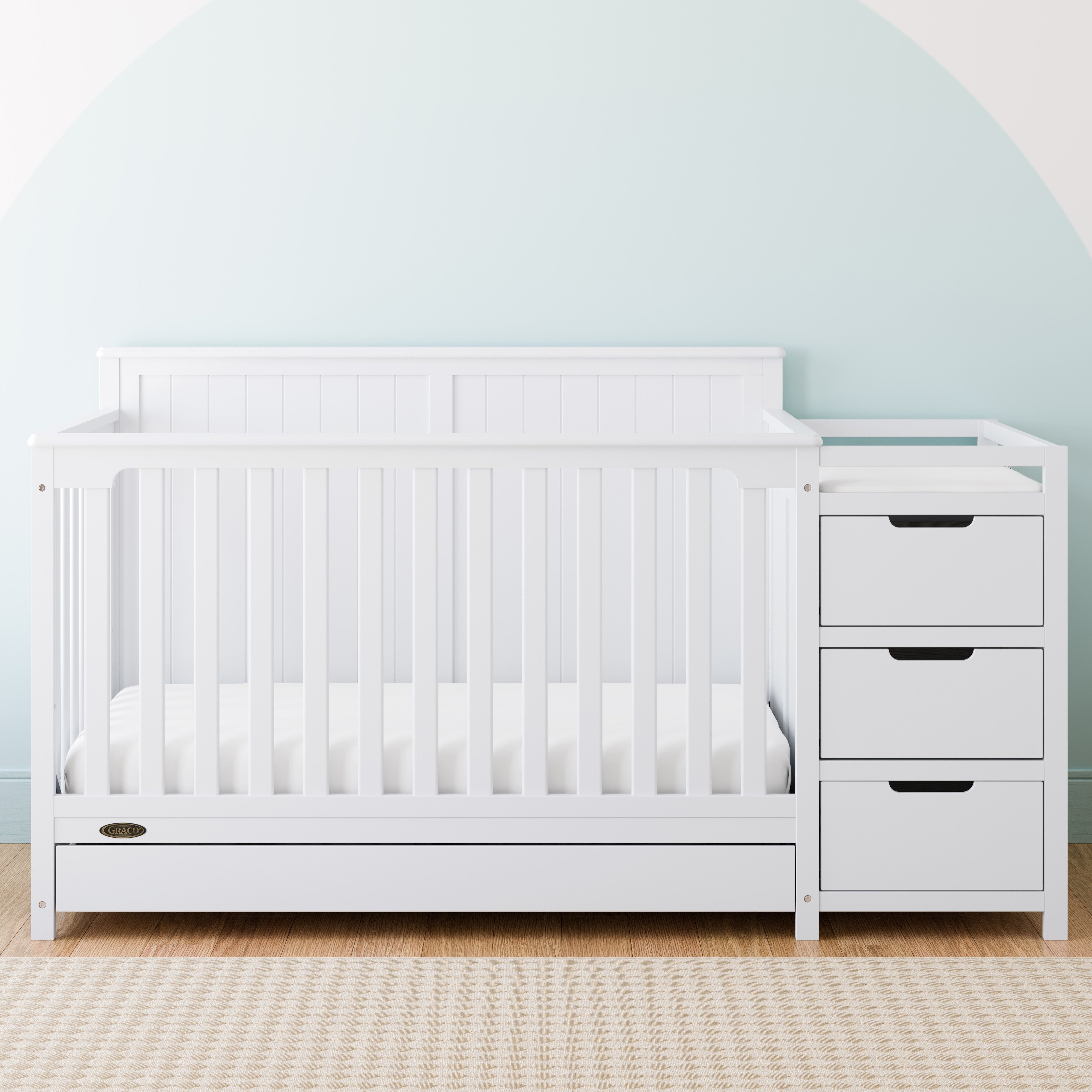 White crib with store drawers